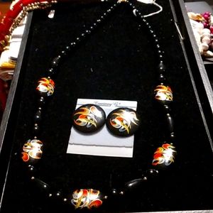 Glamorous lengthy black bead necklace with matching post earrings.
